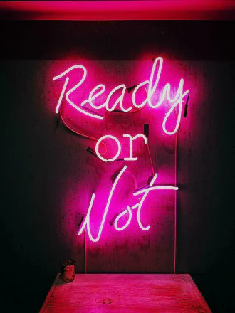Red glowing neon letters: “Ready or Not”