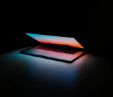 A half-open glowing computer notebook