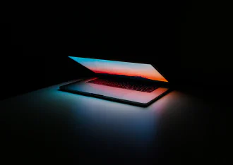 A half-open glowing computer notebook