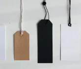 Four empty paper labels on strings