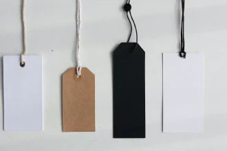 Four empty paper labels on strings
